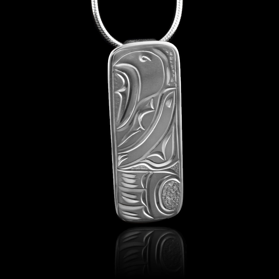 This mens Eagle pendant has a thin, rectangle shape and is made from sterling silver. The top half is the head of the Eagle at a side profile and it is looking upwards. The bottom part of the pendant is a wing with feather designs.