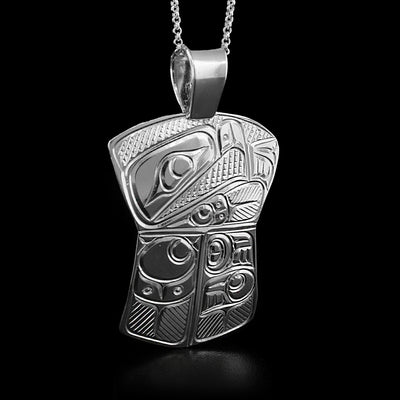 This eagle pendant is in the shape of a shield with a large triangular bail at the top. The upper part depicts the head of an eagle facing the left when worn with a small pointy beak. The bottom half is divided in two and depicts its feathers and wings.