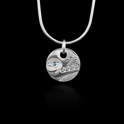 This Sterling Silver Round Wolf Pendant with Garnet is hand carved by artist, Hollie Bartlett. This silver pendant shows the Wolf carved in sterling silver with a blue saphire in the eye.
