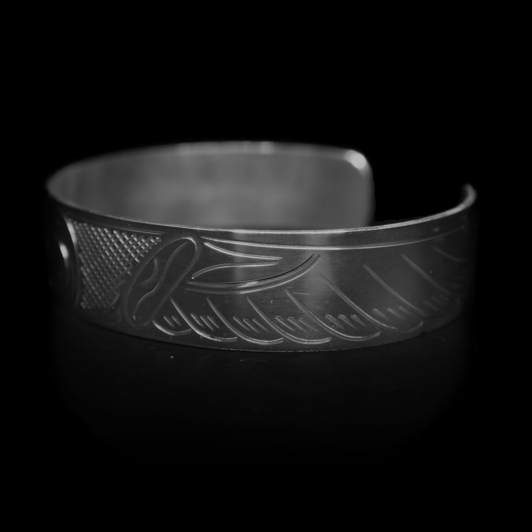Right angle photo of the eagle cuff bracelet depicts one of its spread out wings.