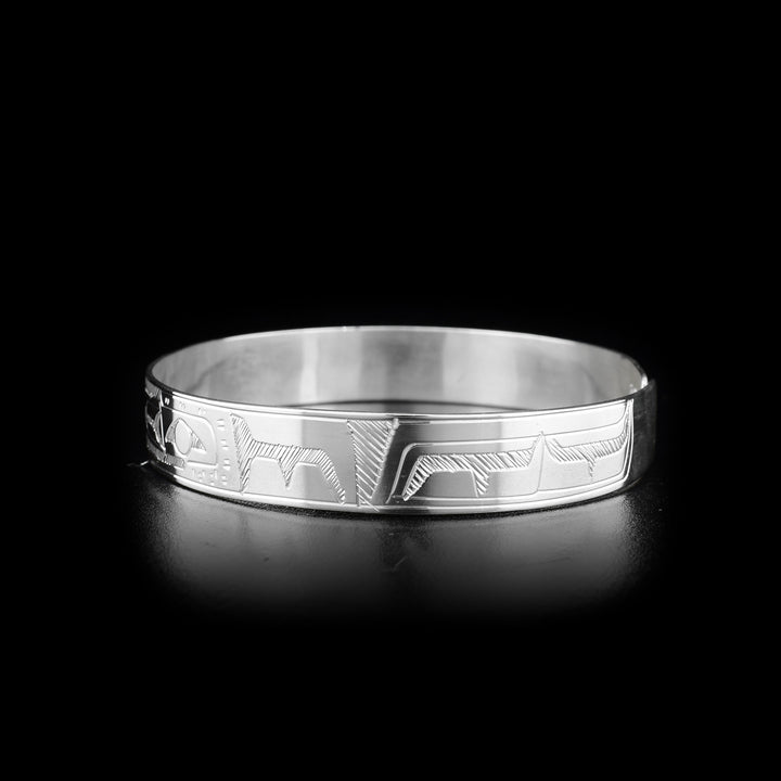 This Raven and Sun bracelet is made from sterling silver and there is a clasp in the back. There are two depictions of the Raven and a depiction of the Sun carved into the band.