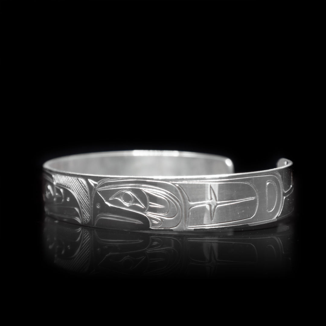 This sterling silver cuff bracelet has a depiction of the Eagle carved into the surface of the band.