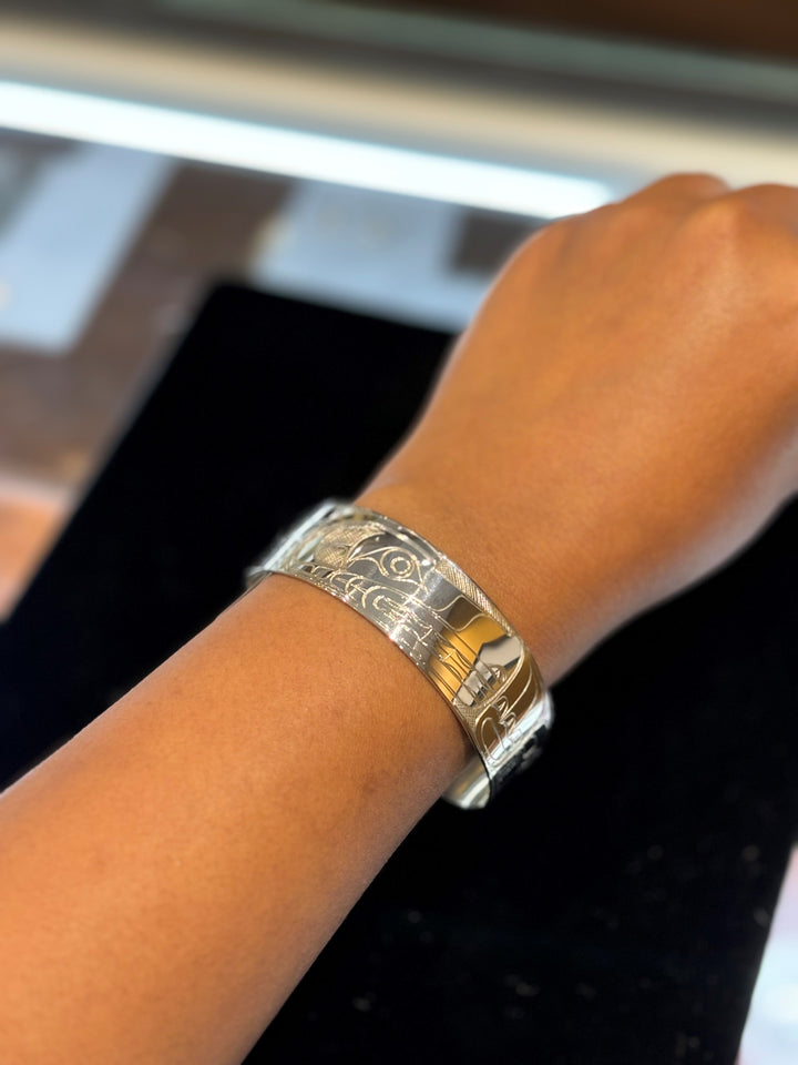 The photo shows a close up of the models wrist and hand while wearing the piece.