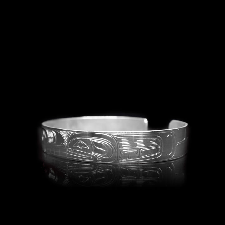 This large, sterling silver cuff bracelet has a depiction of the Orca carved into the surface of the band.