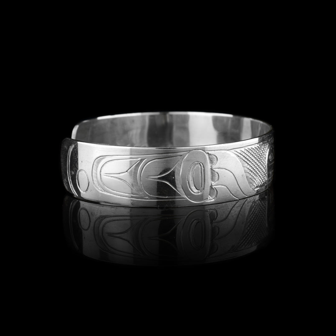 This sterling silver cuff has a single band what a gap in the back. There is a depiction of the Bear carved into the surface of the band.