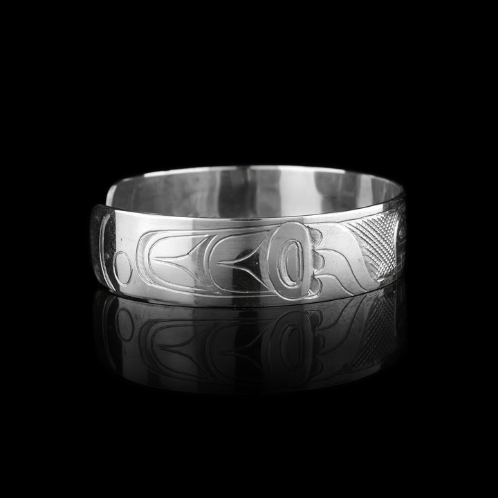 This sterling silver cuff has a single band what a gap in the back. There is a depiction of the Bear carved into the surface of the band.