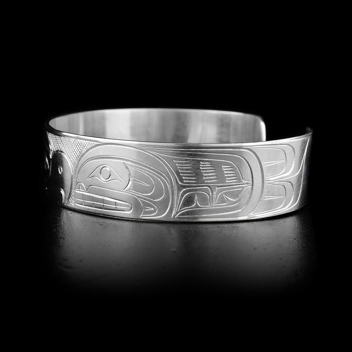 This sterling silver cuff bracelet has a depiction of the Orca and the Thunderbird carved into the surface of the band. The legends are depicted facing each other.