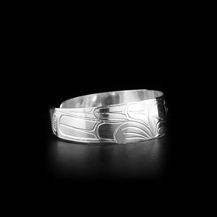 This sterling silver cuff bracelet has a slightly tapered band with a depiction of the Eagle carved into the surface of it.