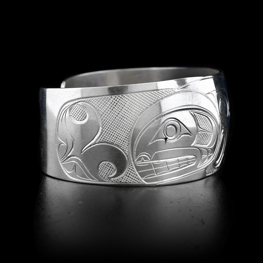 This sterling silver cuff bracelet has a wide band and there is a beautiful depiction of the Orca carved into the surface of the band. 