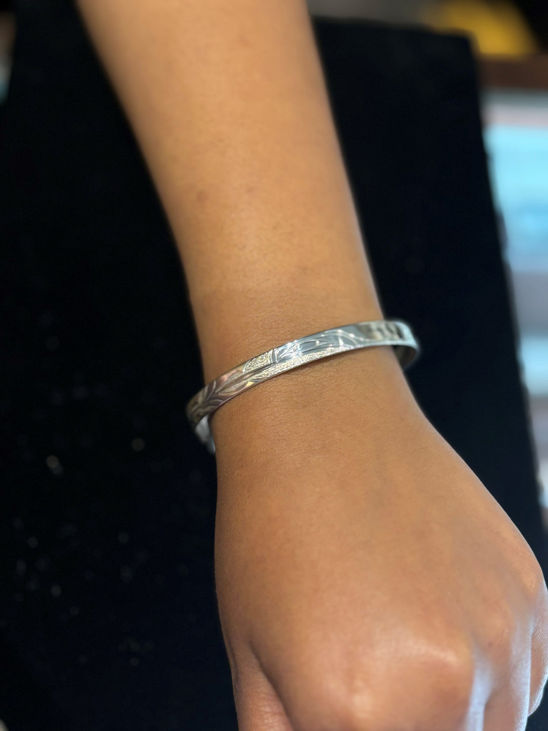 This photo shows a close up of the piece on the model's wrist.