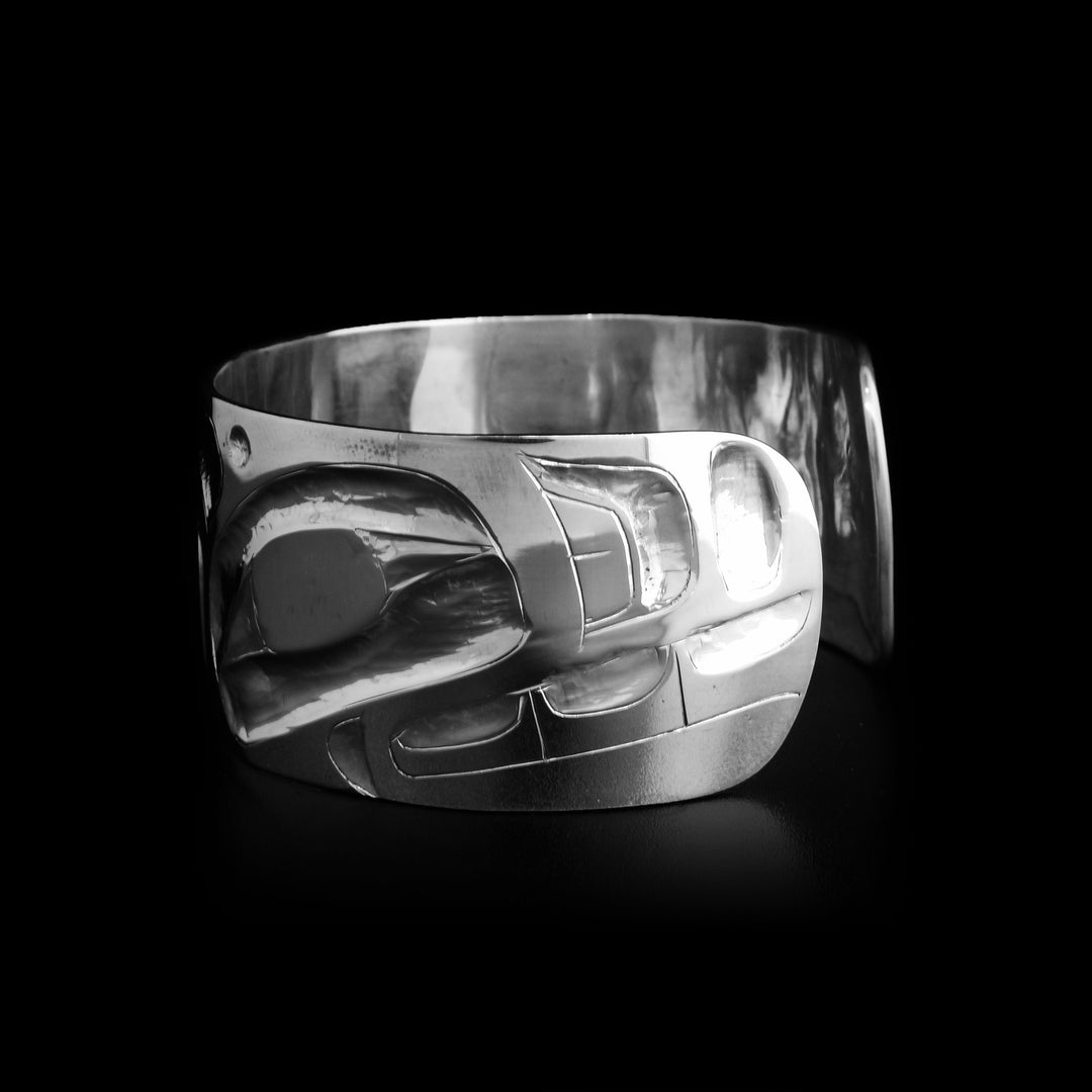 This orca bracelet has one large orca spanning the entirety of the bracelet with the head of the orca facing the right starting on the right side of the bracelet.