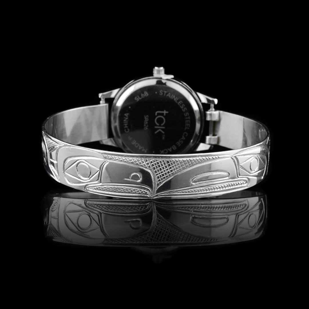 This sterling silver watch has a band with depictions of the Eagle and the Raven carved into it. The face of the watch is also made from sterling silver.