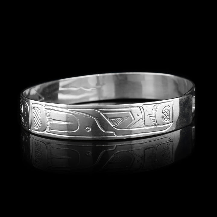 This Hummingbird, Orca and Sun bracelet has a single, sterling silver band with a clasp in the back. There is a depiction of the Sun in the center of the band positioned between the Hummingbird and the Orca. The legends are beautifully carved into the surface of the band.