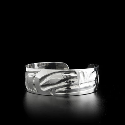This bracelet was carved on sterling silver. It hold the shape of the Wolf. The bracelet measures 0.75" in width, 6.75" in circumference, and has a 0.75" opening.