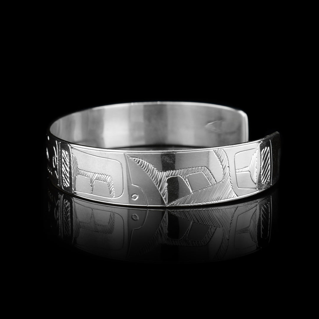 This sterling silver cuff bracelet has a single band with a depiction of the Orca carved into it.