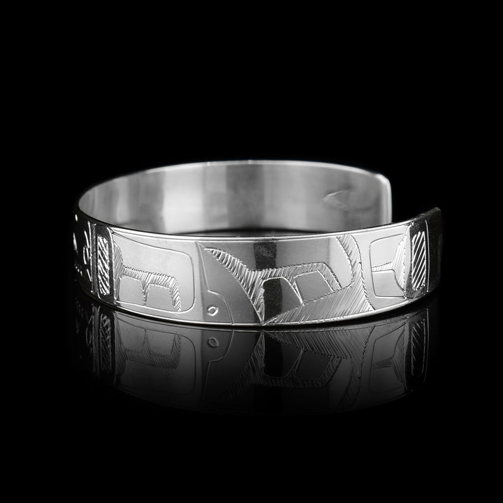 This sterling silver cuff bracelet has a single band with a depiction of the Orca carved into it.