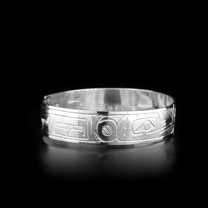 This sterling silver clasp bracelet has two depictions of the Hummingbird and a depiction of the Sun carved into the band. The Hummingbirds are depicted facing the Sun and there is a clasp at the back of the bracelet.