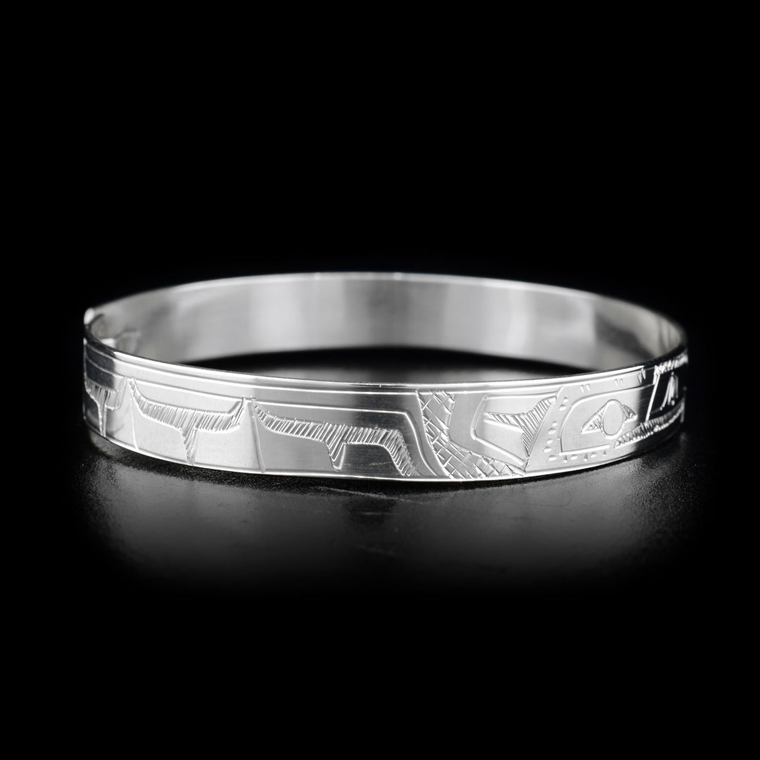 This Hummingbird and Eagle bracelet is made from sterling silver and there are depictions of the Hummingbird and Eagle carved into the band. There is a clasp at the back of it and the Legends are depicted facing each other at the top of the band.