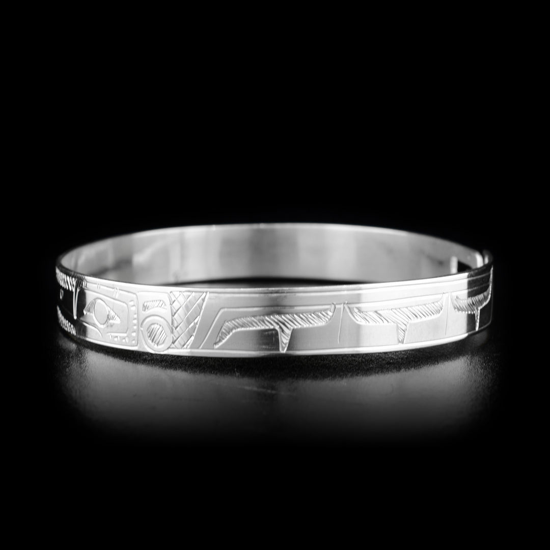 This Hummingbird and Eagle bracelet is made from sterling silver and there are depictions of the Hummingbird and Eagle carved into the band. There is a clasp at the back of it and the Legends are depicted facing each other at the top of the band.