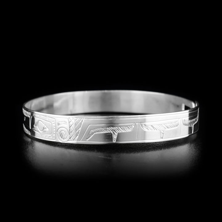 This Hummingbird and Eagle bracelet is made from sterling silver and there are depictions of the Hummingbird and Eagle carved into the band. There is a clasp at the back of it and the Legends are depicted facing each other at the top of the band.