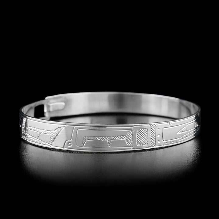 Left angle photo of the bracelet shows carved designs representing the body and fins of the orca. Both sides are identical.