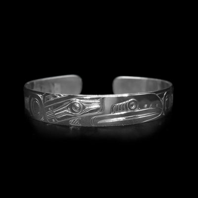 This sterling silver cuff bracelet has a single band with a gap in the back. There is a depiction of the Raven that has been beautifully carved into the surface of the band.