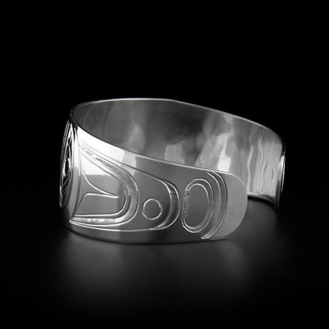Second photo of the silver cuff bracelet shows the orca's head on the right side of the bracelet as well as the tapered ends.