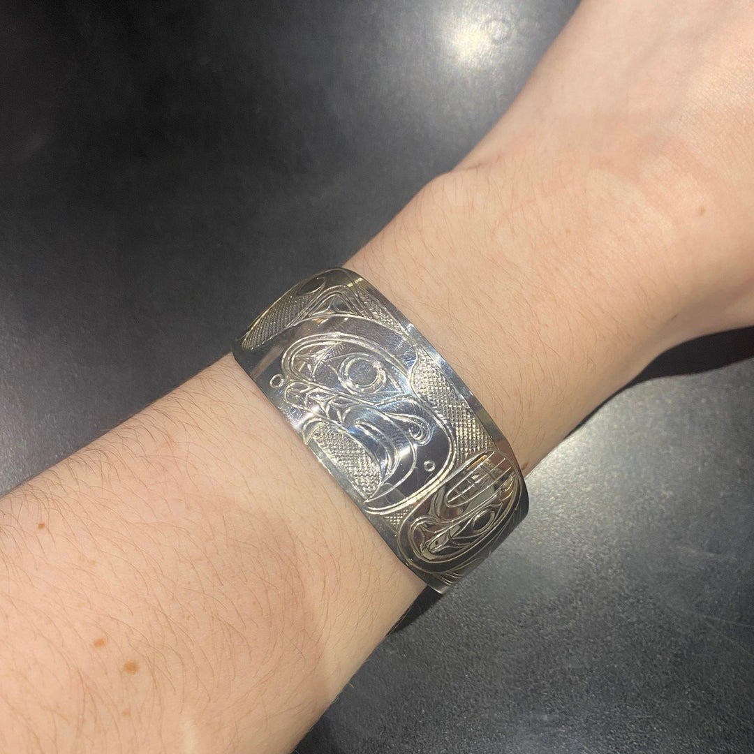 This photo shows the silver cuff bracelet on a female wrist.