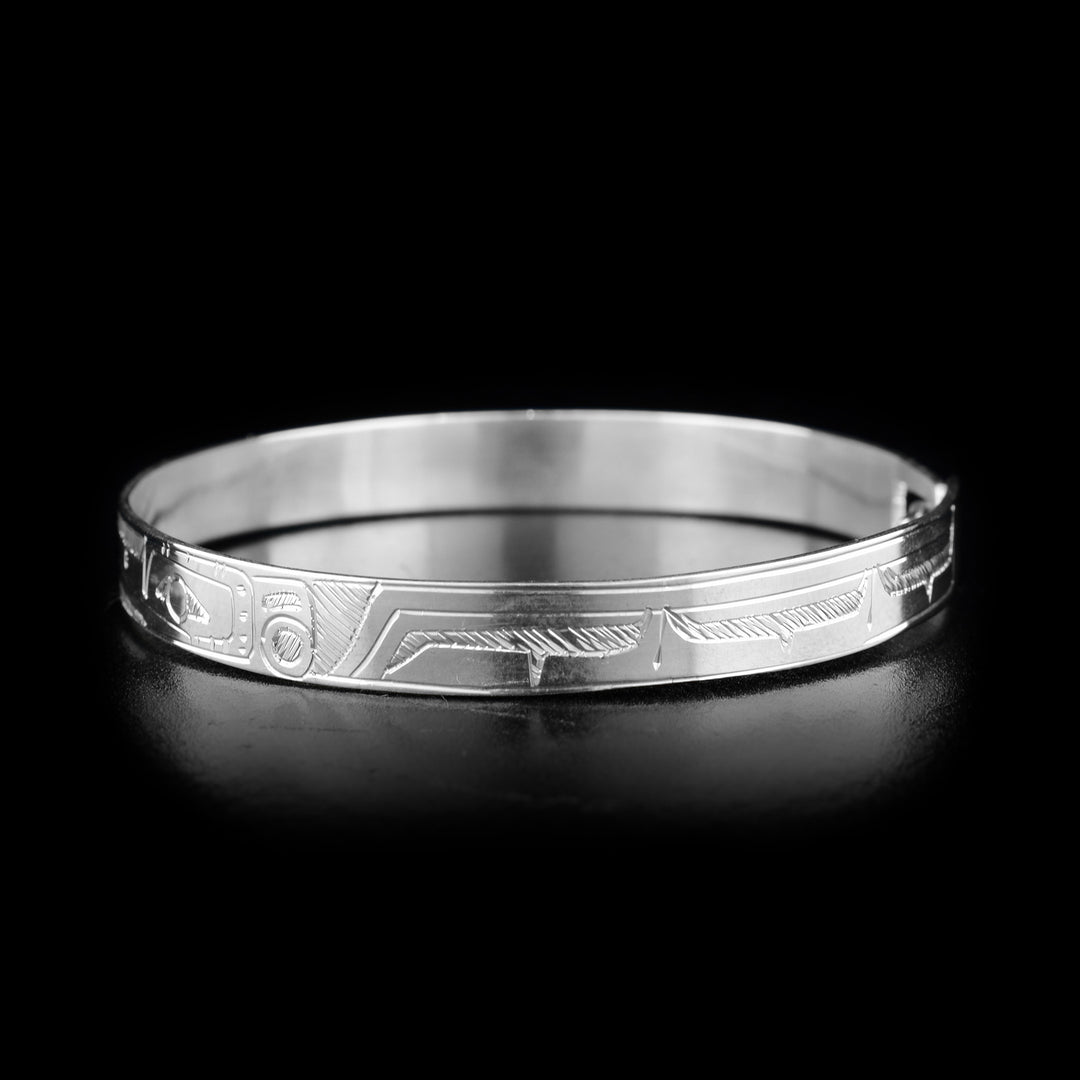 This Hummingbird bracelet is made from sterling silver and there are two depictions of the Hummingbird carved into the band. The band is thin and there is a clasp at the back.