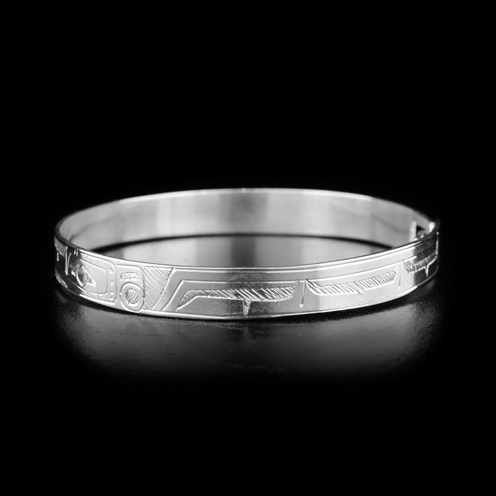 This Hummingbird bracelet is made from sterling silver and there are two depictions of the Hummingbird carved into the band. The band is thin and there is a clasp at the back.