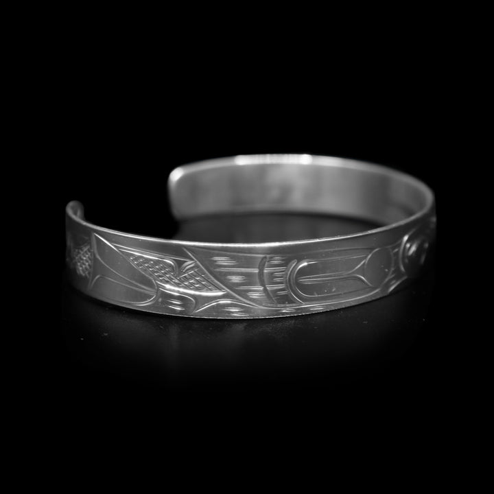 This dainty bracelet has a thin, sterling silver band with a gap in the back. There is a depiction of the Hummingbird that has been beautifully carved into the surface of the band.
