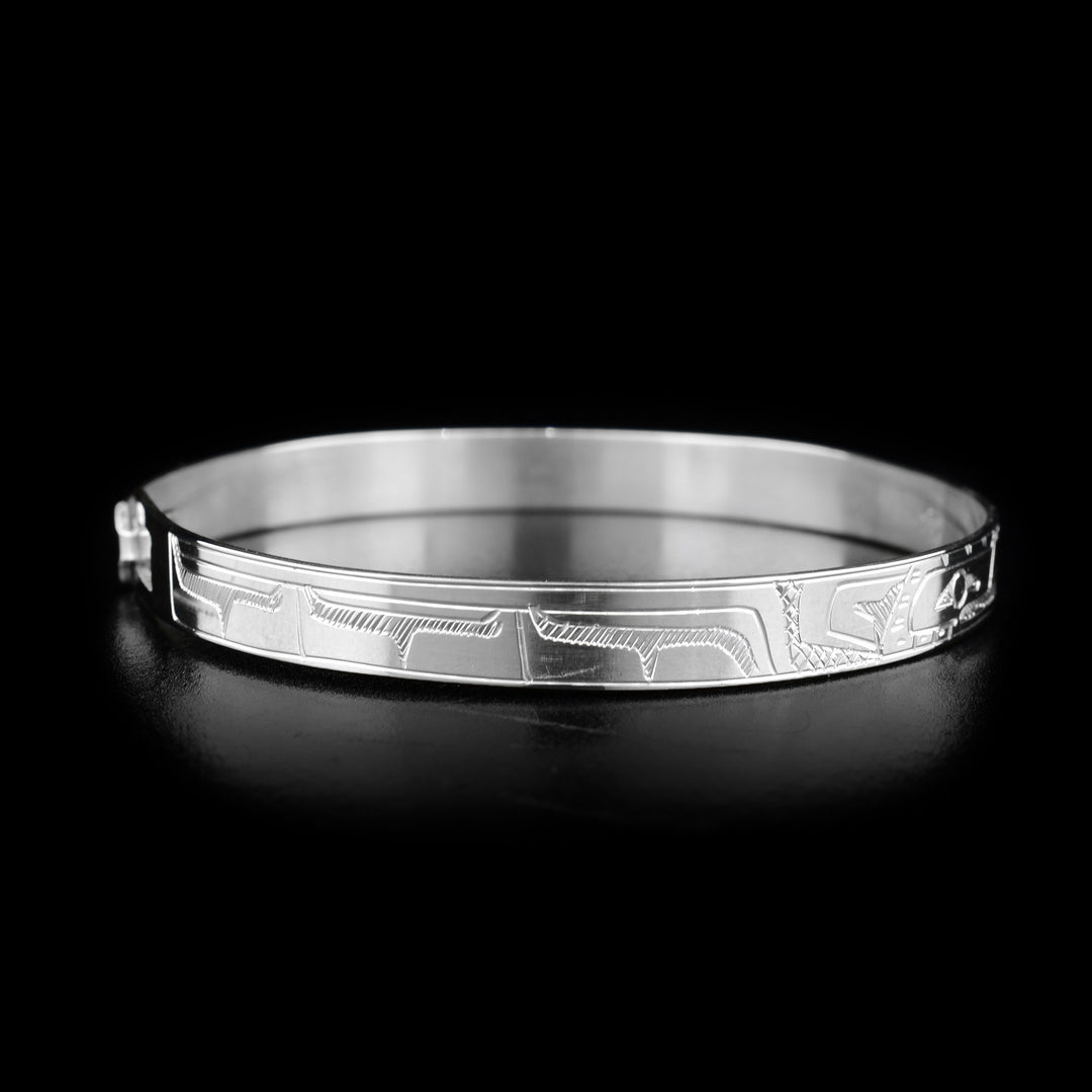 This sterling silver clasp bracelet has a thin band with two depictions of the Eagle carved into the surface of it.