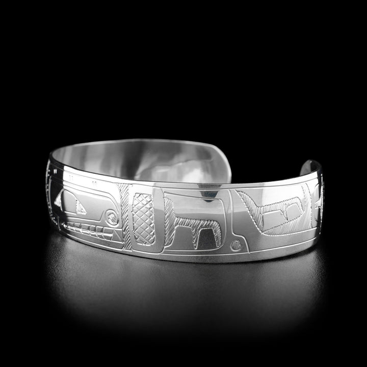 Right angle photo of the bracelet shows carved designs representing the fin and body of the orca. Both sides are identical.