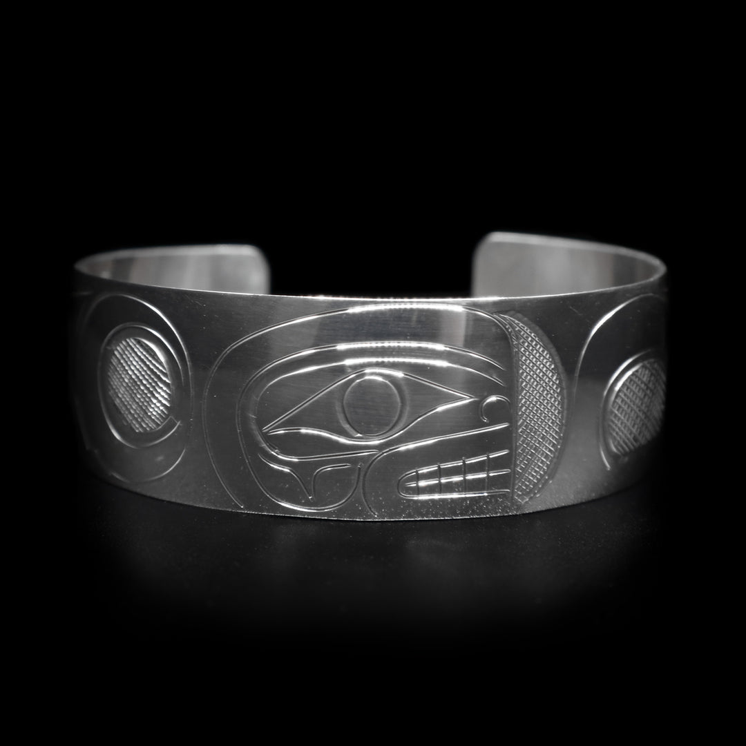 This sterling silver wide cuff bracelet has a full depiction of the Orca beautifully carved into the surface of the band.