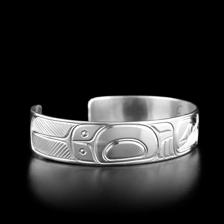 Left angle photo of the bracelet shows carved designs representing the body and wings of the eagle. Both sides are identical.