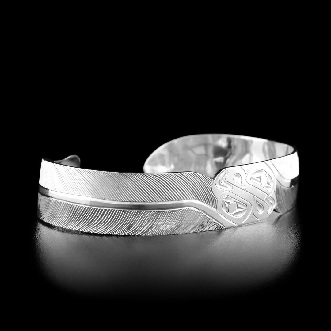 Left angle photo of the bracelet shows a feather-like design spanning from the center to the very end of the bracelet. Both sides are identical.