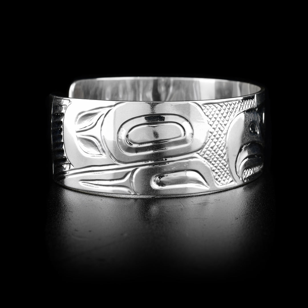 The wide, sterling silver bracelet cuff has a depiction of the Eagle carved into it.