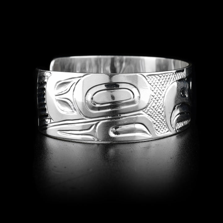 The wide, sterling silver bracelet cuff has a depiction of the Eagle carved into it.