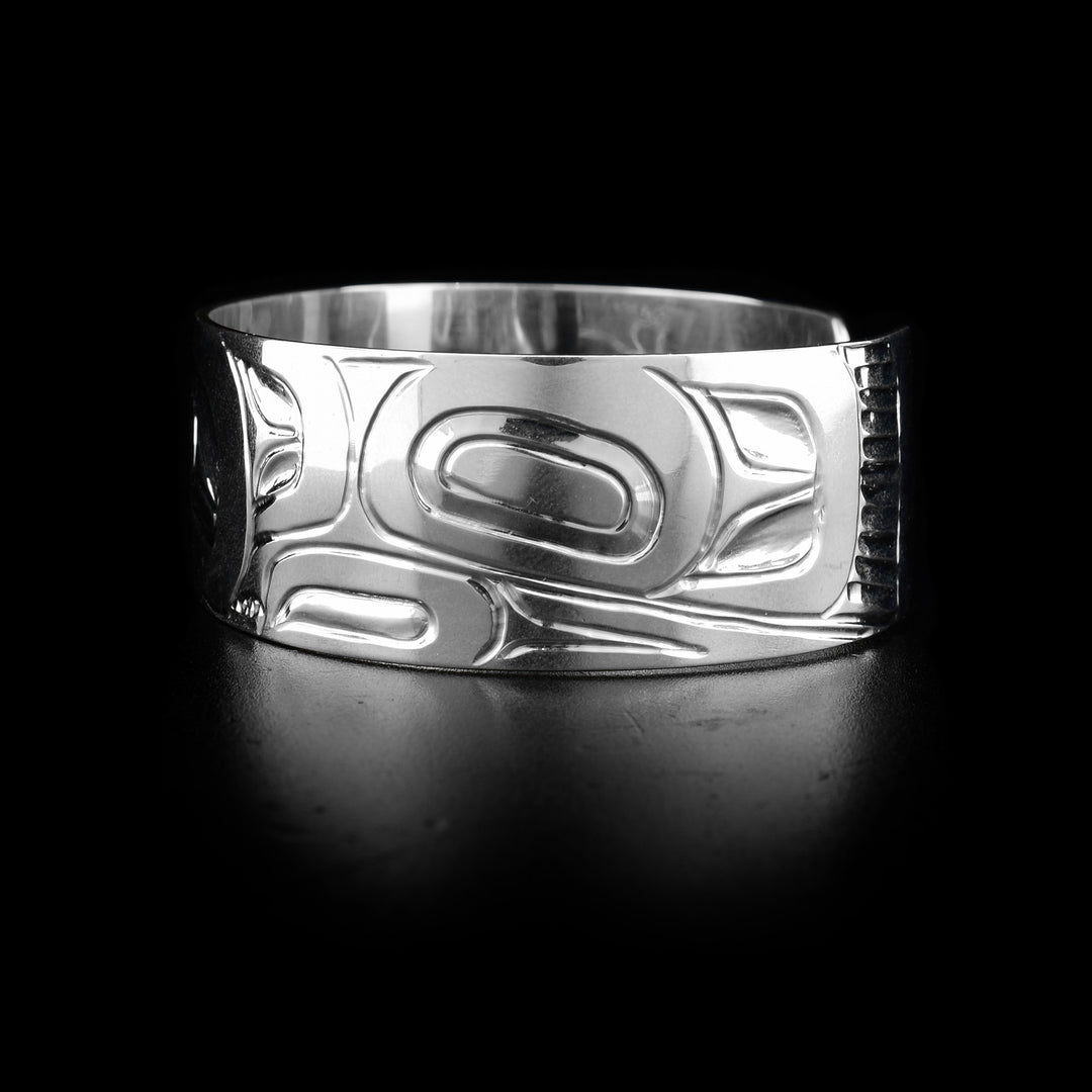 The wide, sterling silver cuff bracelet has a depiction of the Eagle carved into it.