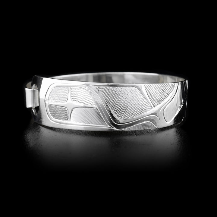 This sterling silver, tapered Orca bracelet has a depiction of the Orca carved into it.