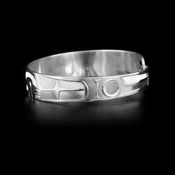 This sterling silver, tapered Orca bracelet has a depiction of the Orca carved into it.