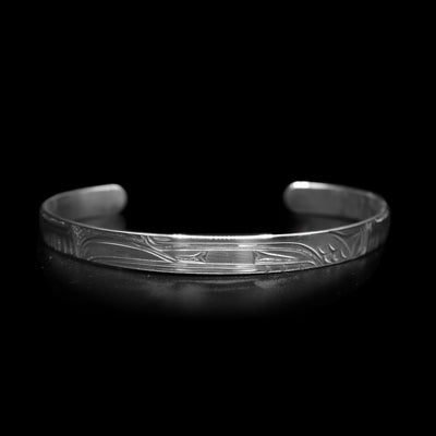 This dainty bracelet has a thin, sterling silver band with a gap in the back. There is a depiction of the Raven that has been beautifully carved into the surface of the band.