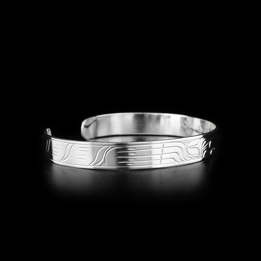 This sterling silver cuff bracelet has a depiction of the Wolf carved into the surface of the band.