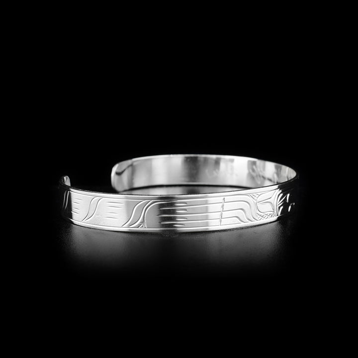 This sterling silver cuff bracelet has a depiction of the Wolf carved into the surface of the band.