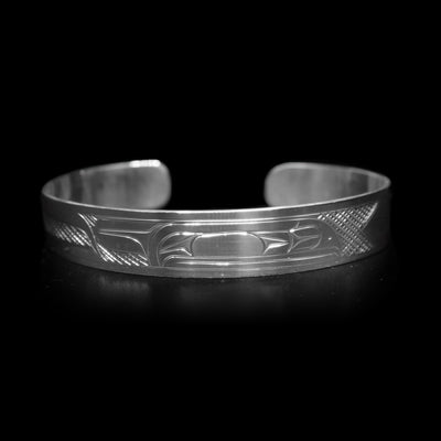 This Raven bracelet has a single, sterling silver band with a gap in the back. There is a depiction of the Raven carved across the surface of the band and a small Sun carved in the side of the band.