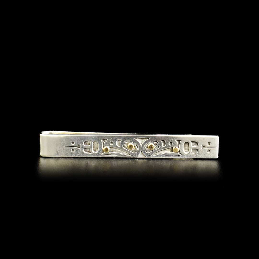 This sterling silver money clip holds a picture of the Raven holding the Sun. The eyes of the Raven as well as the Sun are gold. 