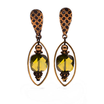 These crystal earrings have a light green, rectangular Austrian crystal dangling with brass accents from a patterned brass post. Around the crystal is an oval brass accent.