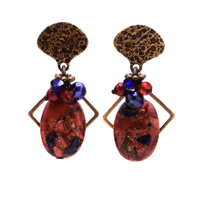 These goldstone earrings have a brass stud front with a cluster of blue and red stones and a larger oval goldstone piece attached at the bottom.