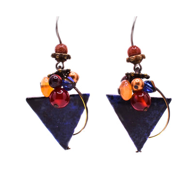 These dumortierite earrings are triangular in shape with clusters of yellow, red, and blue gemstones above attached to the hook.