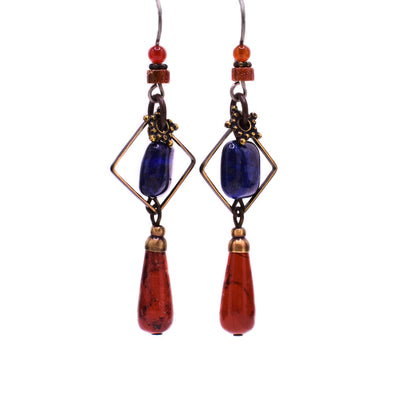 These lapis earrings have a square lapis piece in the center with a teardrop shaped jasper attached at the bottom. There are goldstone, agate, and brass accents all throughout.